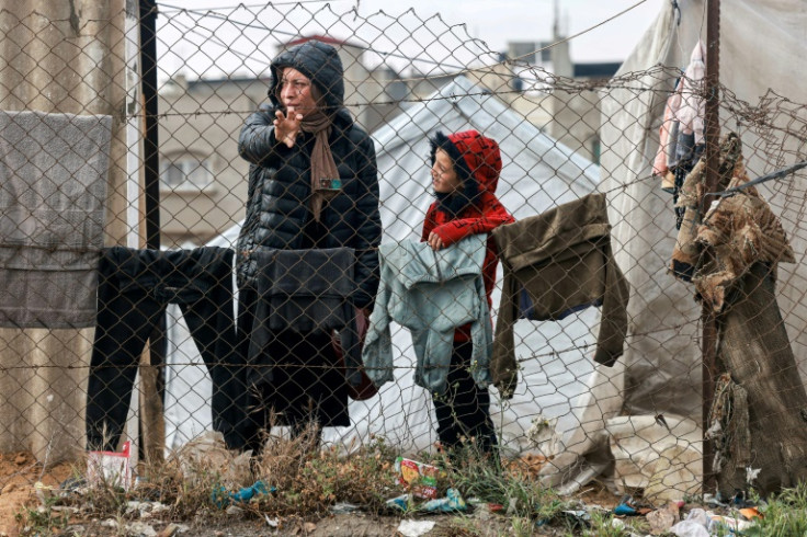 A woman and child stand  in Rafah in the southern Gaza Strip