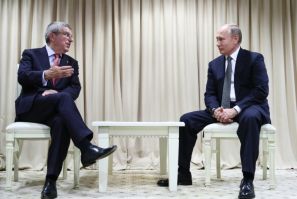 Russian President Vladimir Putin listens to International Olympic Committee (IOC) president Thomas Bach, back in 2019