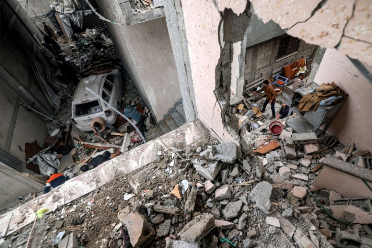 People search through the rubble of a building that was hit by overnight Israeli bombardment in Rafah in the southern Gaza Strip, on March 19, 2024