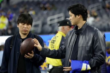 Baseball star Shohei Ohtani talks with his interpreter Ippei Mizuhara before an NFL football game between the New Orleans Saints and the Los Angeles Rams at SoFi Stadium