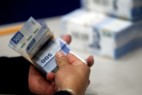 An employee checks banknotes at a Bank of Mexico printing facility in El Salto, Jalisco state