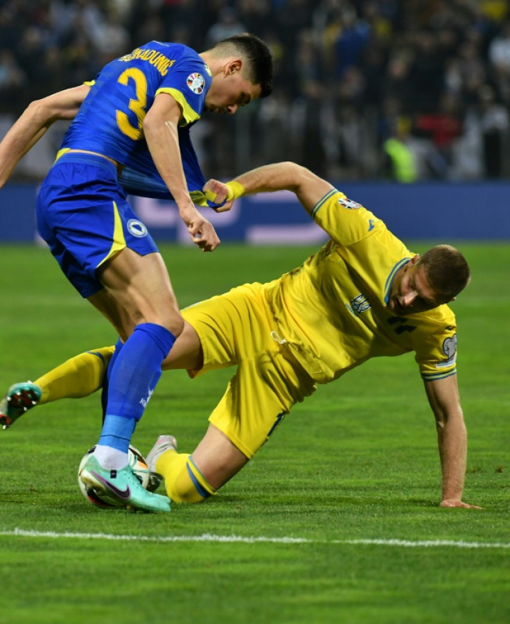 Tussle: Bosnia and Herzegovina's Dennis Hadzikadunic (L) clashes with Ukraine match-winner Artem Dovbyk