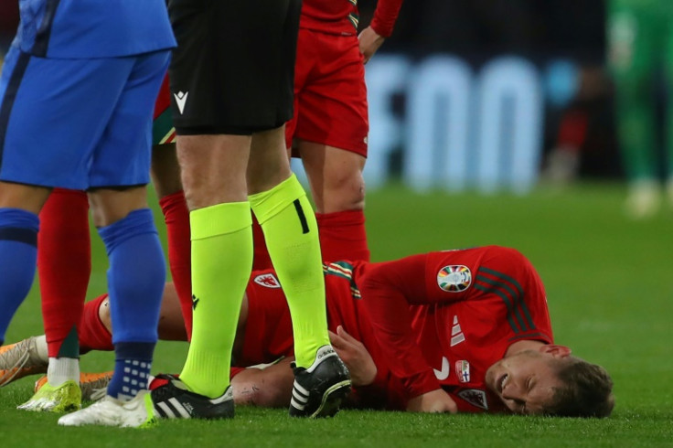 Pain: Wales' David Brooks lies injured during the playoff with Finland