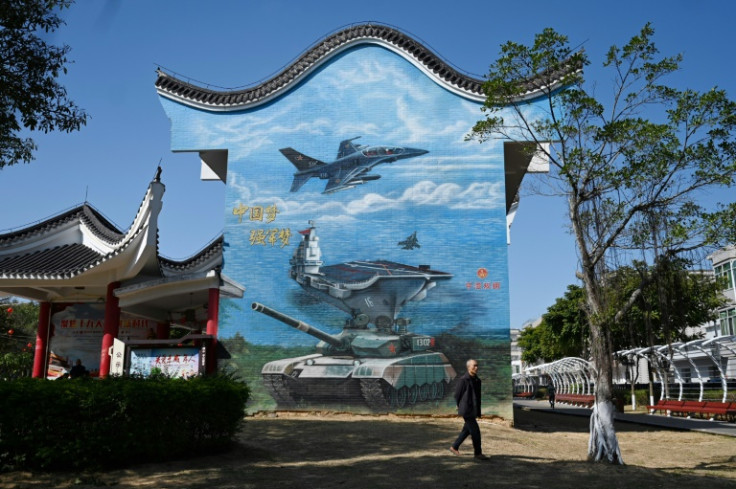 A man walks past a military-themed mural at a public park on Pingtan Island  in China's southeast Fujian province, the closest point to Taiwan’s main island