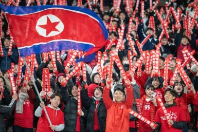North Korea's fans cheer before the World Cup qualifier in Tokyo