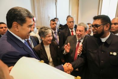 Venezuela's President Nicolas Maduro (L) shakes hands with Guyana's President Irfaan Ali during a meeting this month