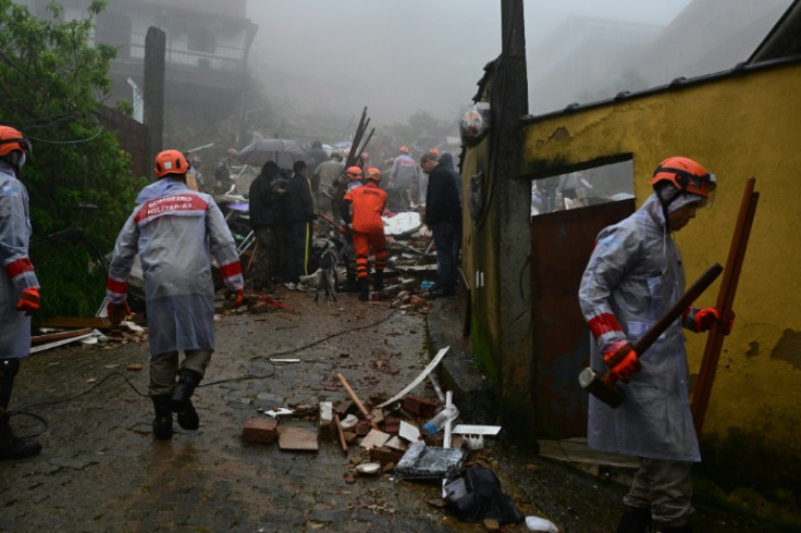 Members of the Civil Defense, firefighters and local residents work to rescue victims of heavy rains in Petropolis, Brazil