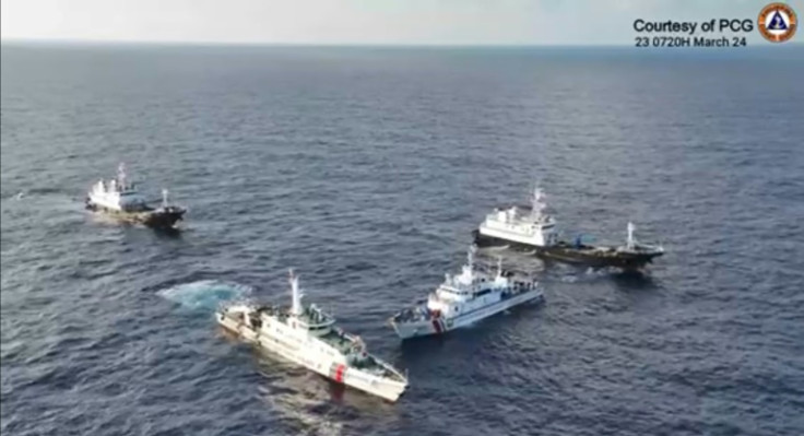 A a frame grab from aerial video footage shows a China Coast Guard ship (2nd L) and vessels identified by the Philippine Coast Guard as 'Chinese Maritime Militia' (L and R) surrounding the Philippine ship BRP Cabra (2nd R)