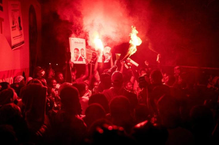 Supporters of Faye celebrate at his coalition headquarters in Dakar