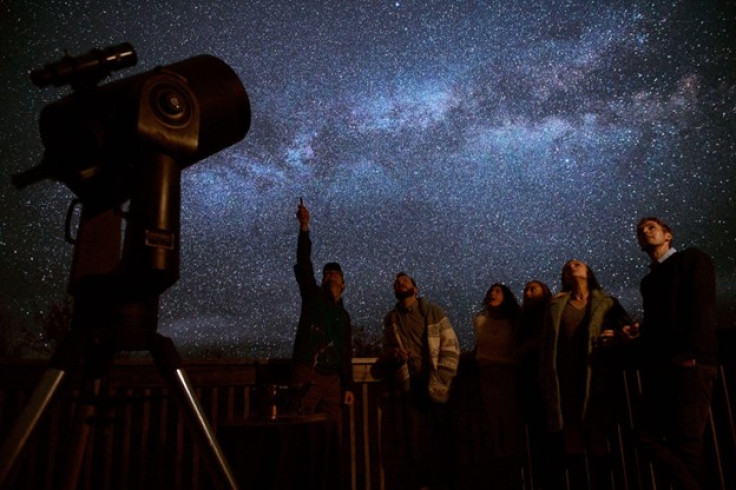 A group of Trout Point Lodge guests stargazing