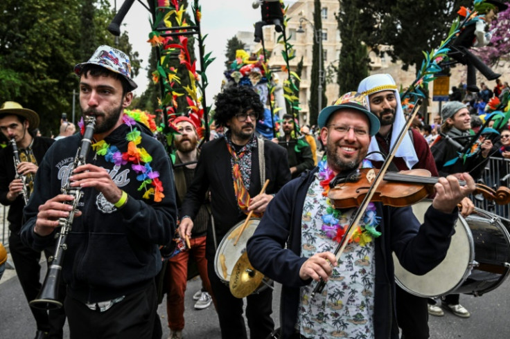 Smiling through: Musicians play during the subdued Purim parade through Jerusalem