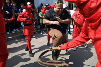Devils known as "talciguines" lash sinners in a town square in El Salvador in a centuries-old Holy Week tradition