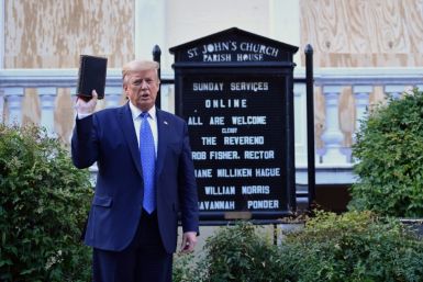 Then US president Donald Trump holds up a Bible outside of St John's Episcopal church near the White House in June 2020 after peaceful protesters were ejected from the area