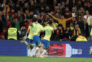 Brazil midfielder Lucas Paqueta (L) celebrates scoring his team's third goal in the draw against Spain in Madrid