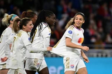 Delphine Cascarino (R) celebrates with team-mates after scoring Lyon's second goal against Benfica