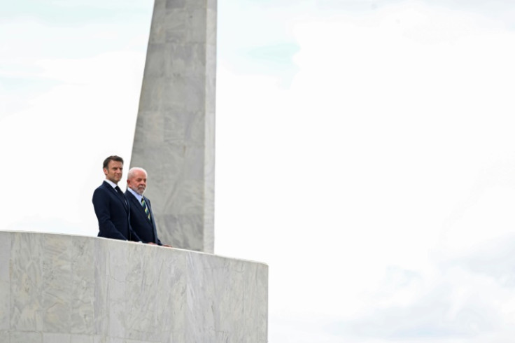France's President Emmanuel Macron (L) and Brazil's President Luiz Inacio Lula da Silva (R) look on after a bilateral meeting at the Planalto Palace in Brasilia