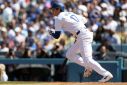 Japanese star Shohei Ohtani of the Los Angeles Dodgers singles in the fifth inning of his home debut for the Dodgers, a 7-1 triumph over St. Louis