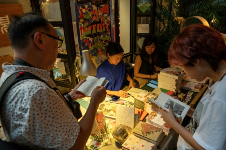 People browse books at independent bookstore Mount Zero after it closed due to government pressure