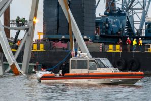 US authorities hope to create a temporary channel while they remove the wreckage of Baltimore's Francis Scott Key Bridge, seen here in this handout photo from the Coast Guard