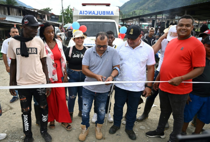 Nelson Enrique Ríos (C), alias Gafas, a leader of the main dissident group of former FARC fighters, cuts the ribbon during the inauguration of a health centre and delivery of an ambulance, which his group helped finance