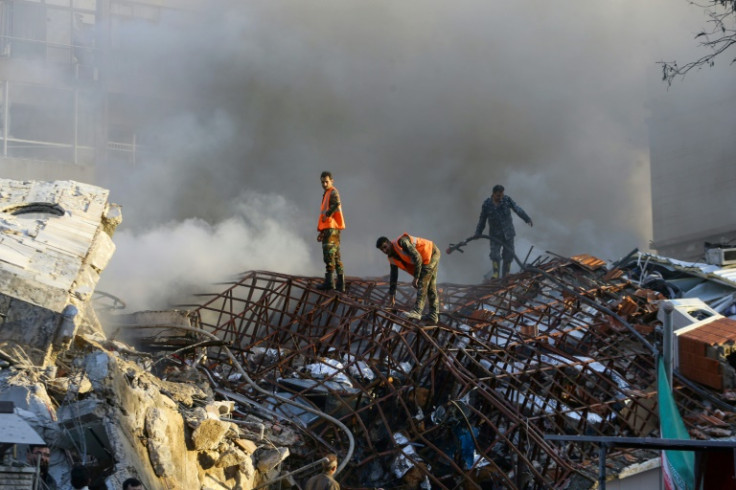 Emergency personnel at the site of strikes which hit an annex building of the Iranian embassy in Syria's capital Damascus, on April 1, 2024