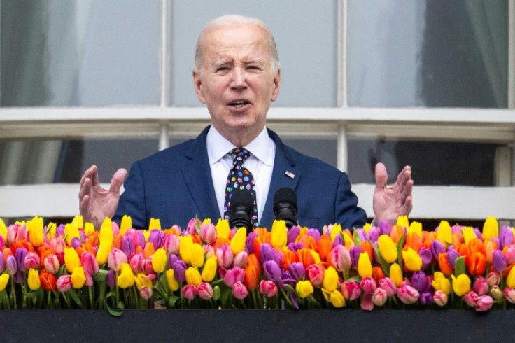 US President Joe Biden speaks from the balcony of the White House during the annual Easter Egg Roll on the South Lawn in Washington, DC, on April 1, 2024.