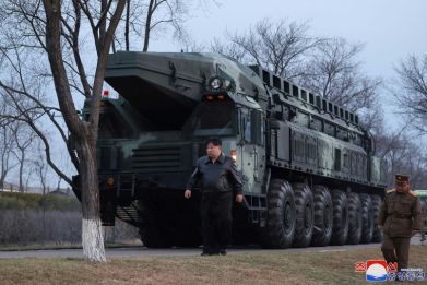 North Korean leader Kim Jong Un inspects the first test-fire of a new-type intermediate-range solid-fueled ballistic missile