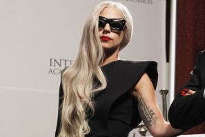 Sporting a hospital gown and a surgical cap, Lady Gaga sang the opening lines of her new single as she was wheeled out by two medical professionals on a hospital stretcher, said a media report.