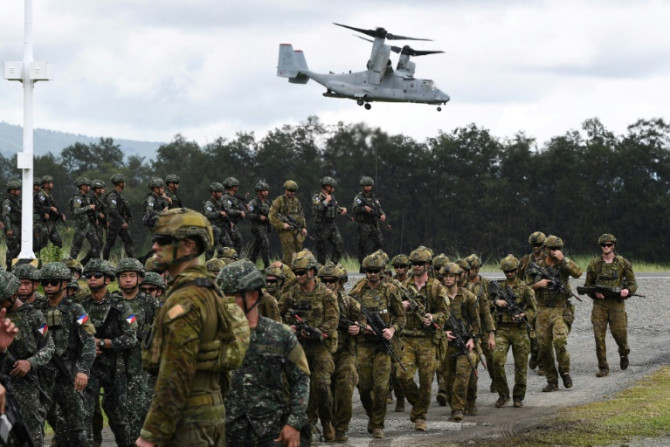 Philippine and Australian soldiers march in formation during the 2023 military exercise Alon, a joint amphibious landing drill