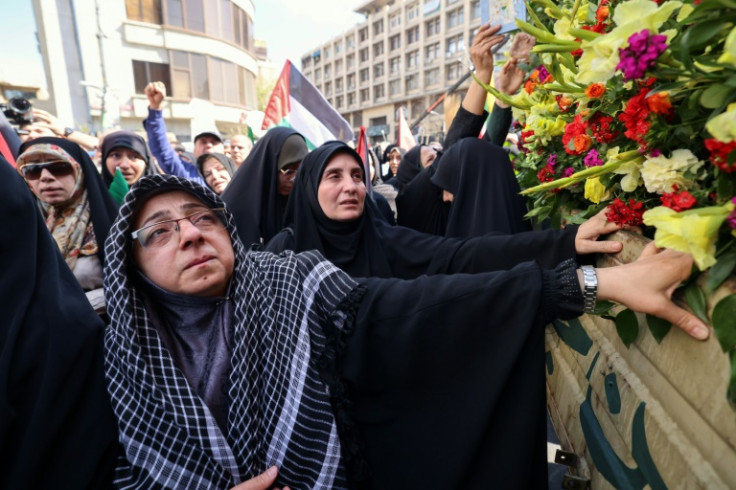 Iranians attend the funeral in Tehran of the seven Islamic Revolutionary Guard Corps members