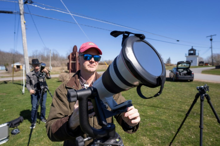 John Bills tests his camera equipment on the eve of a total solar eclipse across North America, in Cape Vincent, New York, on April 7, 2024