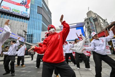 Campaigners for the ruling People Power Party dance during an event in Seoul