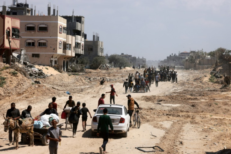 Palestinians who had taken refuge in Rafah begin returning to Khan Yunis after the Israeli pullout