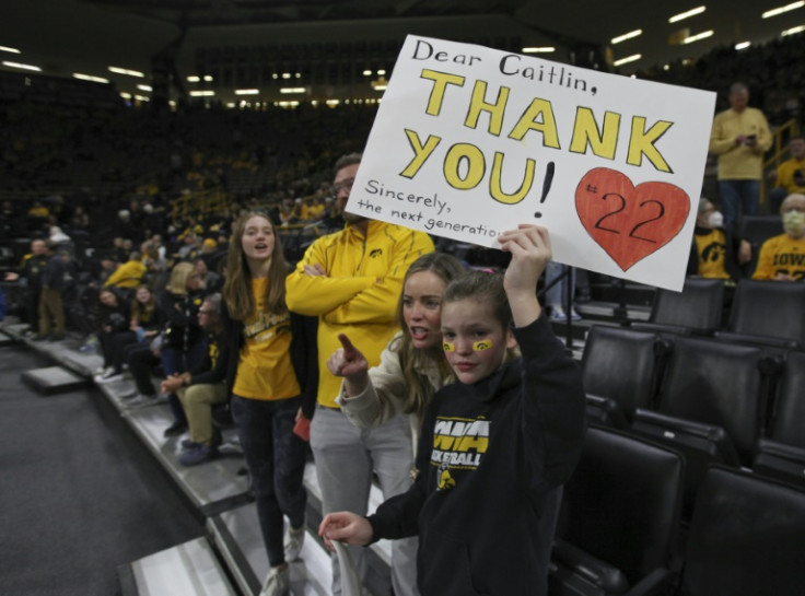Young fans hold up signs thanking Caitlin Clark at a game in Iowa