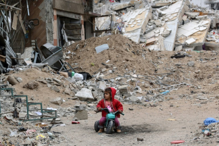 A Palestinian child plays near a building destroyed by Israeli bombardment in Gaza City on April 8, 2024