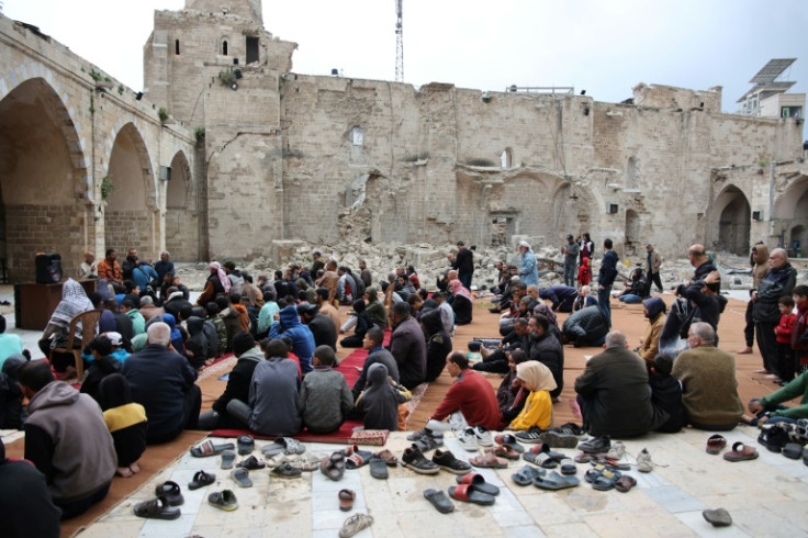 Palestinians pray in the courtyard of Gaza City's historic Omari Mosque, which has been heavily damaged by Israeli bombardment