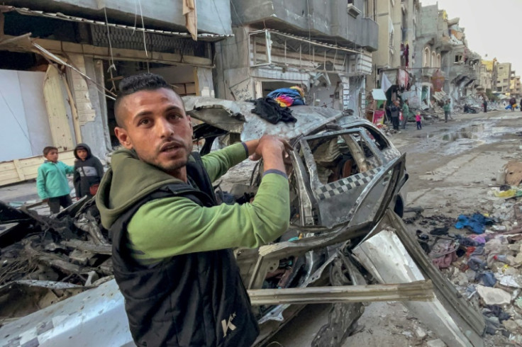 A man gestures in front of the car in which three sons of Hamas leader Ismail Haniyeh were killed