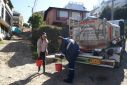 Graphic designer Clara Escobar collects drinking water from a water truck in La Calera, near Bogota