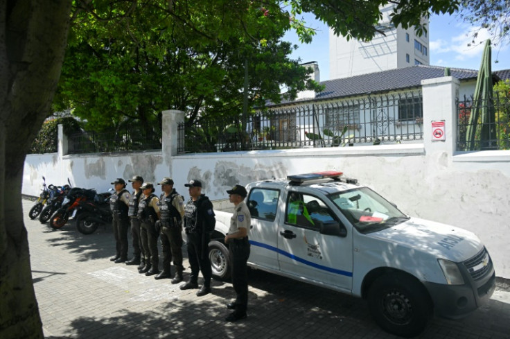 Police officers guard the Mexican embassy in Quito