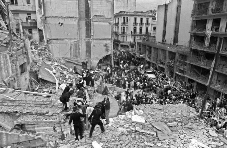 Firemen and policemen search for wounded people after a bomb exploded at the Argentinian Israelite Mutual Association (AMIA) in Buenos Aires on July 18, 1994