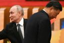 The United States says that China under President Xi Jinping (R) is helping Russia, led by President Vladimir Putin (L), undertake its biggest military expansion since Soviet times