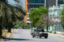 A police vehicle monitors the area near the National Palace and Ministry of Finance building in Port-au-Prince