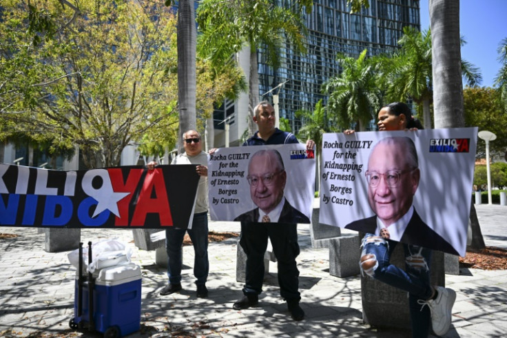 People protest demanding the "maximum sentence" for the former US Ambassador to Bolivia, Victor Manuel Rocha, who admitted to spying for Cuba, outside a courthouse in Miami, Florida on April 12, 2024
