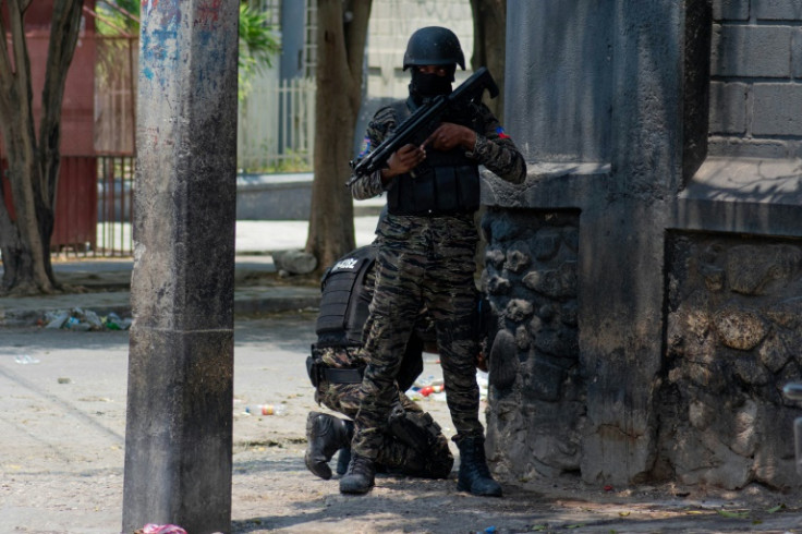 Haitian policemen stand guard on a street corner amid gang violence in Port-au-Prince on April 8, 2024