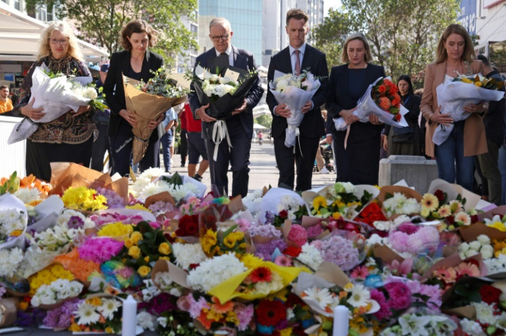 Australian Prime Minister Anthony Albanese (C, with NSW premier Chris Minns) leave flowers in tribute to the victims of the shopping mall attack