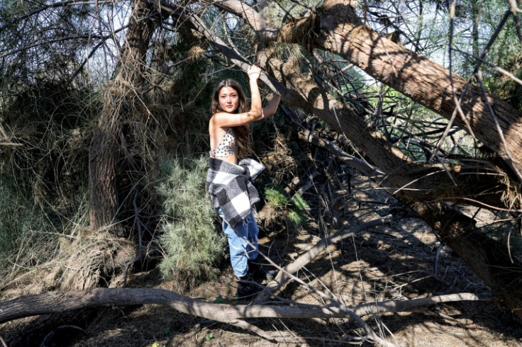 Hannah Zedek, one of the survivors of the October 7 attack on the Supernova music festival by Palestinian militants, shows journalists her hiding spot