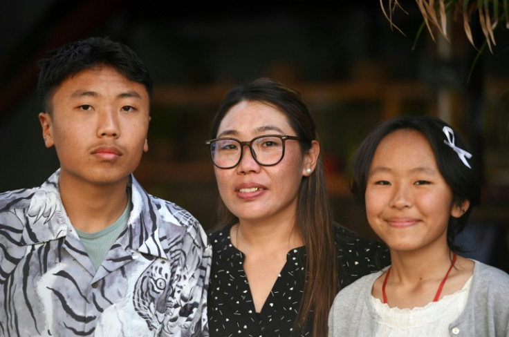 Nima Doma Sherpa (C), wife of avalanche victim and mountaineer Tsering Onchu Sherpa who died in the 2014 avalanche, poses with their son Pemba Chetten Sherpa (L) and daughter Nima Yangji Sherpa
