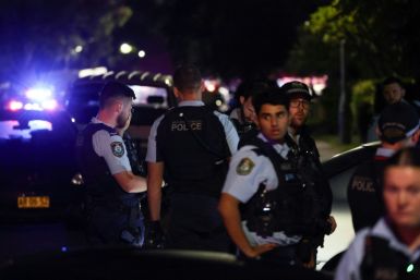 Police gather outside the Christ the Good Shepherd Church in Sydney's western suburb of Wakeley on Monday night