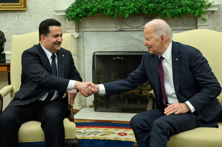 US President Joe Biden (R) shakes hands with the Prime Minister of Iraq Mohammed Shia al-Sudani in the Oval Office of the White House in Washington, DC on April 15, 2024. Sudani's trip to Washington, his first since taking office in October 2022, was or