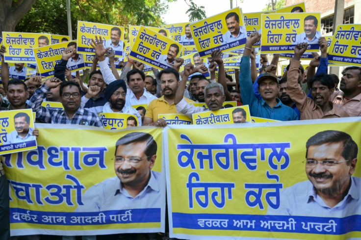 Supporters and activists of the Aam Aadmi Party hold placards and posters featuring their leader and Delhi's Chief Minister Arvind Kejriwal demanding his release from prison